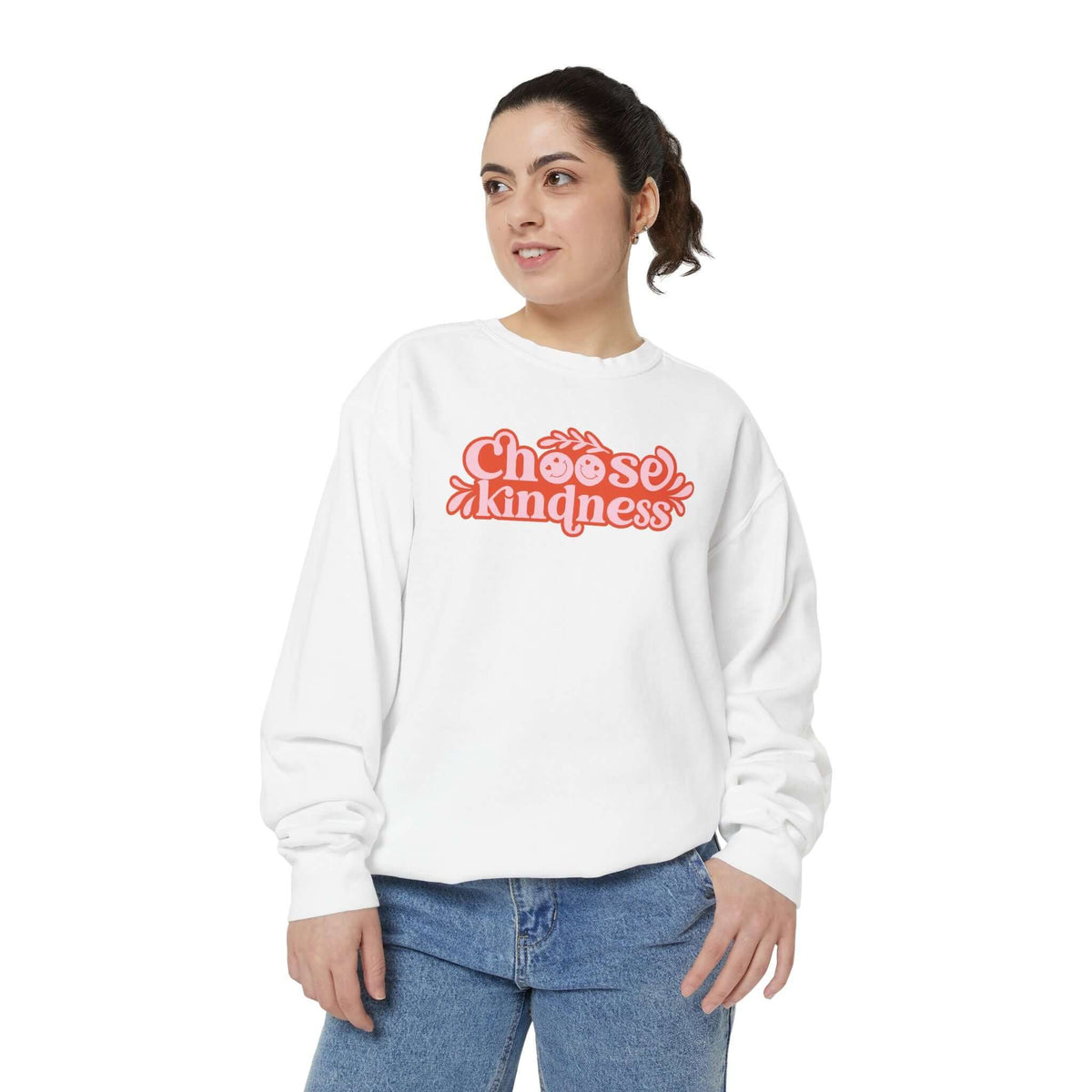 Model wearing a white Choose Kindness sweatshirt with vintage-inspired artwork.