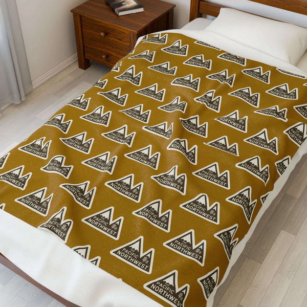 Pacific Northwest Heights Mountain Lightweight Cozy Blanket displayed on a bed with a stylish design.