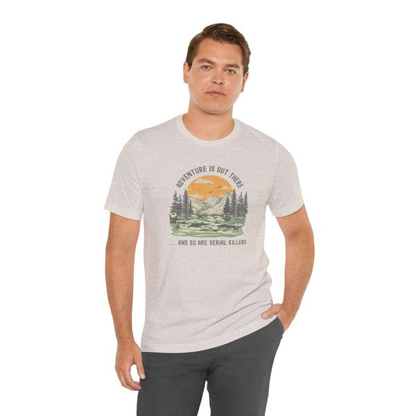 Man wearing Adventure Is Out There And So Are Serial Killers tee in outdoor setting, perfect for true crime fans.