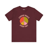 Choose Peace Every Day premium soft tee featuring a colorful peace symbol on a burgundy background.