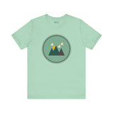 Minimalist forest-themed soft tee in northwest style with simple mountain graphic on a light green background. Perfect for nature lovers.