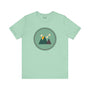 Minimalist forest-themed soft tee in northwest style with simple mountain graphic on a light green background. Perfect for nature lovers.