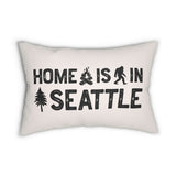 Home is in Seattle Lumbar Accent Pillow featuring bold lettering and campfire, sasquatch, and tree designs.