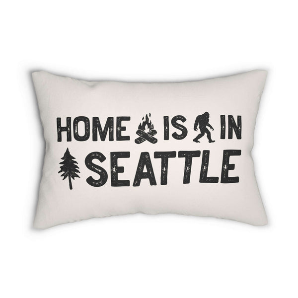 Home is in Seattle Lumbar Accent Pillow featuring bold lettering and campfire, sasquatch, and tree designs.