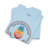 Visit the Hidden Legends tee featuring colorful Bigfoot design on blue fabric, celebrating Northwest spirit.
