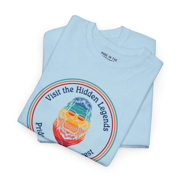 Visit the Hidden Legends tee featuring colorful Bigfoot design on blue fabric, celebrating Northwest spirit.