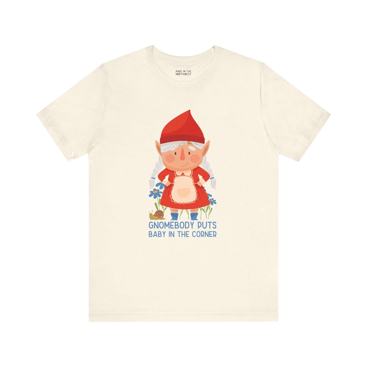 "Gnomebody Puts Baby in the Corner soft tee featuring an adorable female gnome with playful design on a cream shirt."