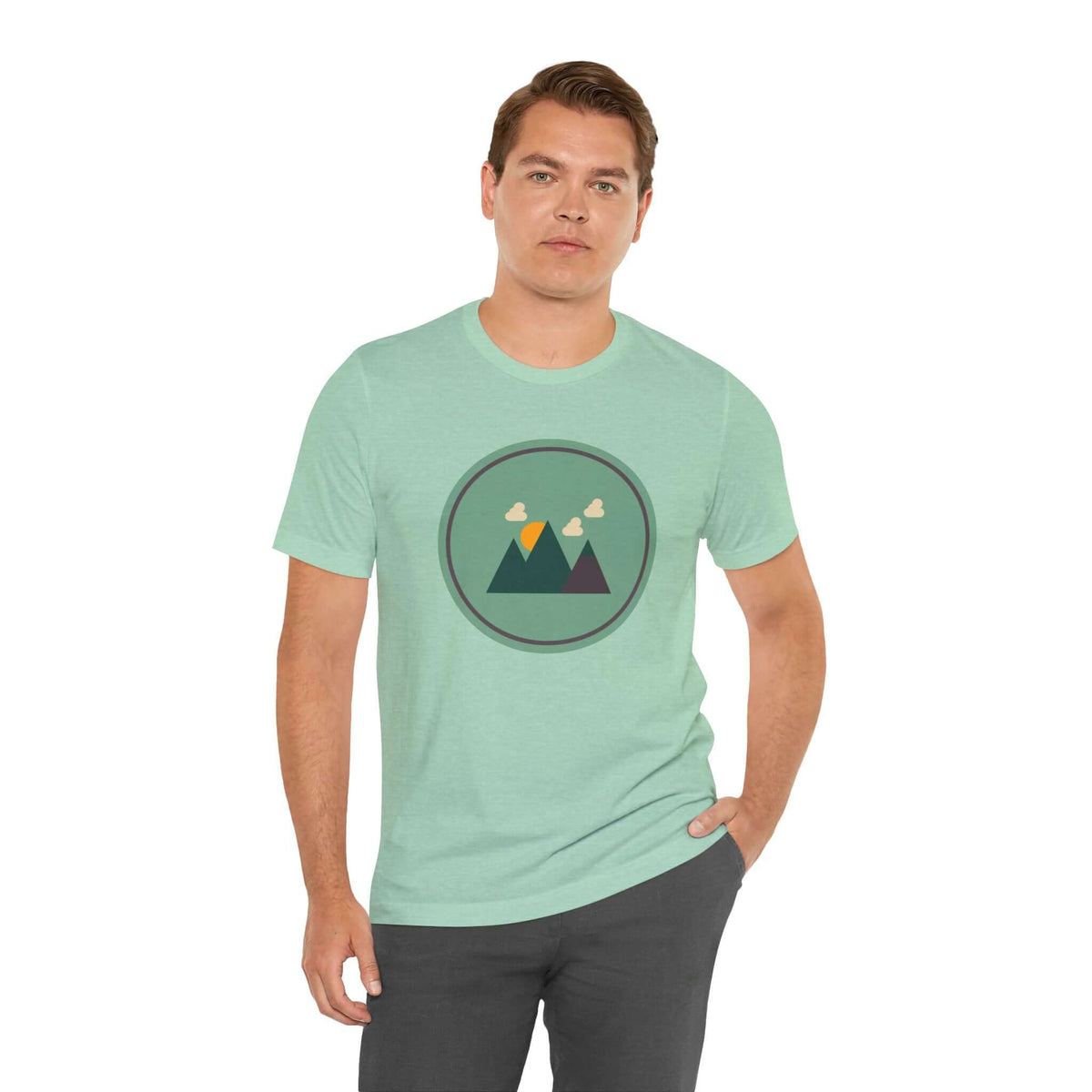 Minimalist forest tee with Northwest design on male model, featuring a simple mountain silhouette on a light green shirt.