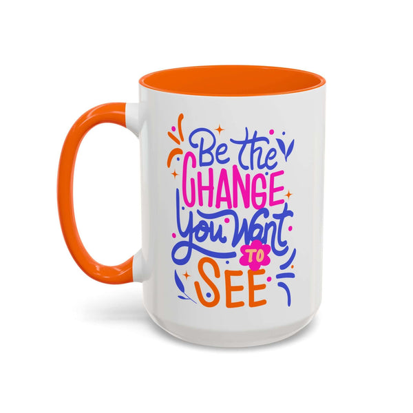 Be the Change You Want to See Mug with colorful hand-lettered design and orange interior.
