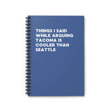 Spiral notebook with blue cover, text: 'Things I Said While Arguing Tacoma is Cooler Than Seattle'