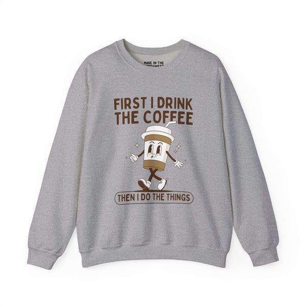 Gray sweatshirt with text "First I Drink the Coffee Then I Do the Things" featuring a playful coffee cup graphic.