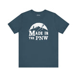 Made in the PNW T Shirt – Distressed Mountain Graphic Tee on a blue background with a white graphic design.