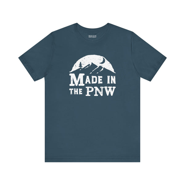 Made in the PNW T Shirt – Distressed Mountain Graphic Tee on a blue background with a white graphic design.