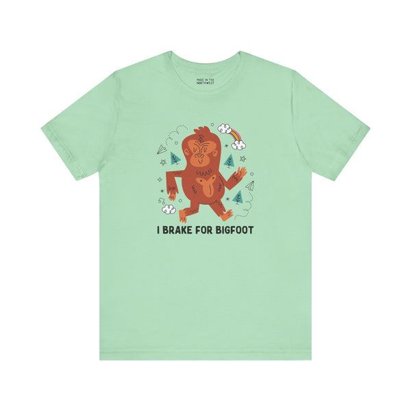 I Brake for Bigfoot soft tee featuring a whimsical Sasquatch graphic on mint green fabric.