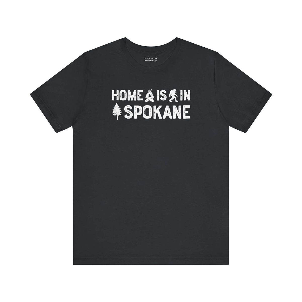 Home Is in Spokane Tee showcasing the phrase and illustrations of campfire, Bigfoot, and a tree.