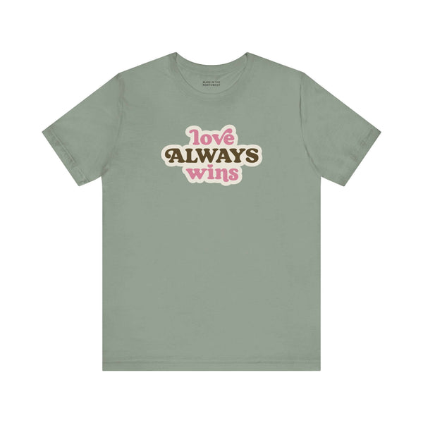 love always wins t shirt in olive green with bold typography celebrating love and pride.