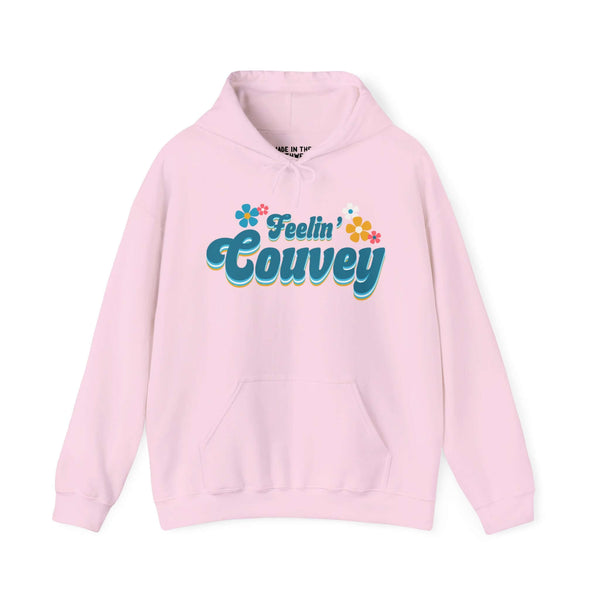 Pink retro hoodie with "Feelin' Couvey" design, featuring 70s font and colorful flowers, celebrating Vancouver, Washington's spirit.