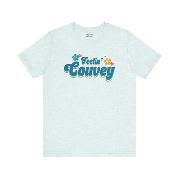 Feelin' Couvey retro tee featuring 70s font and colorful flowers, perfect for adding vintage charm to your wardrobe.
