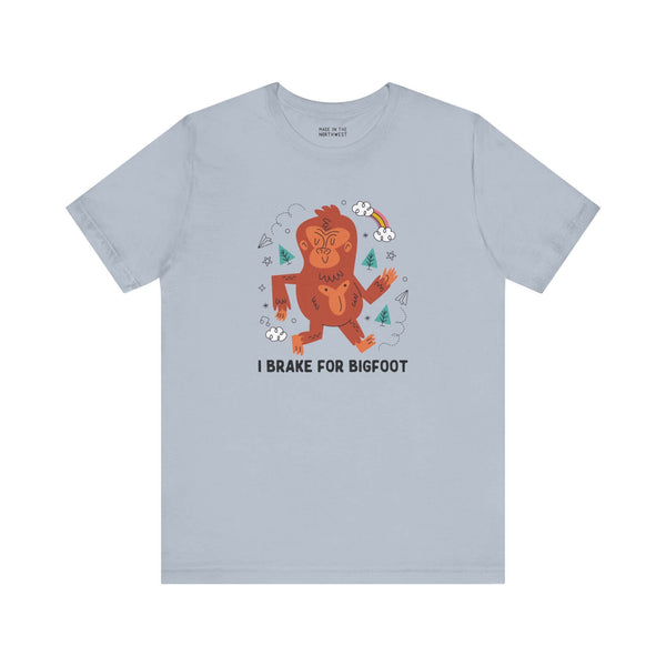 I Brake for Bigfoot Soft Tee Show your playful side and love for local folklore with our "I Brake for Bigfoot" Sasquatch Tee. This fun design features the phrase "I Brake for Bigfoot" alongside a whimsical graphic of a Sasquatch, perfect for those who enj