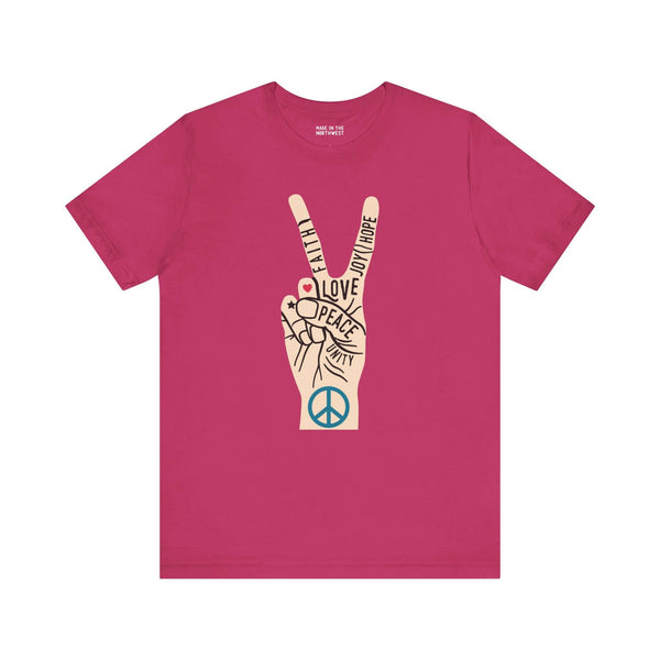 Power in Peace Premium Soft Tee featuring a hand making a peace sign with uplifting words on a pink shirt.