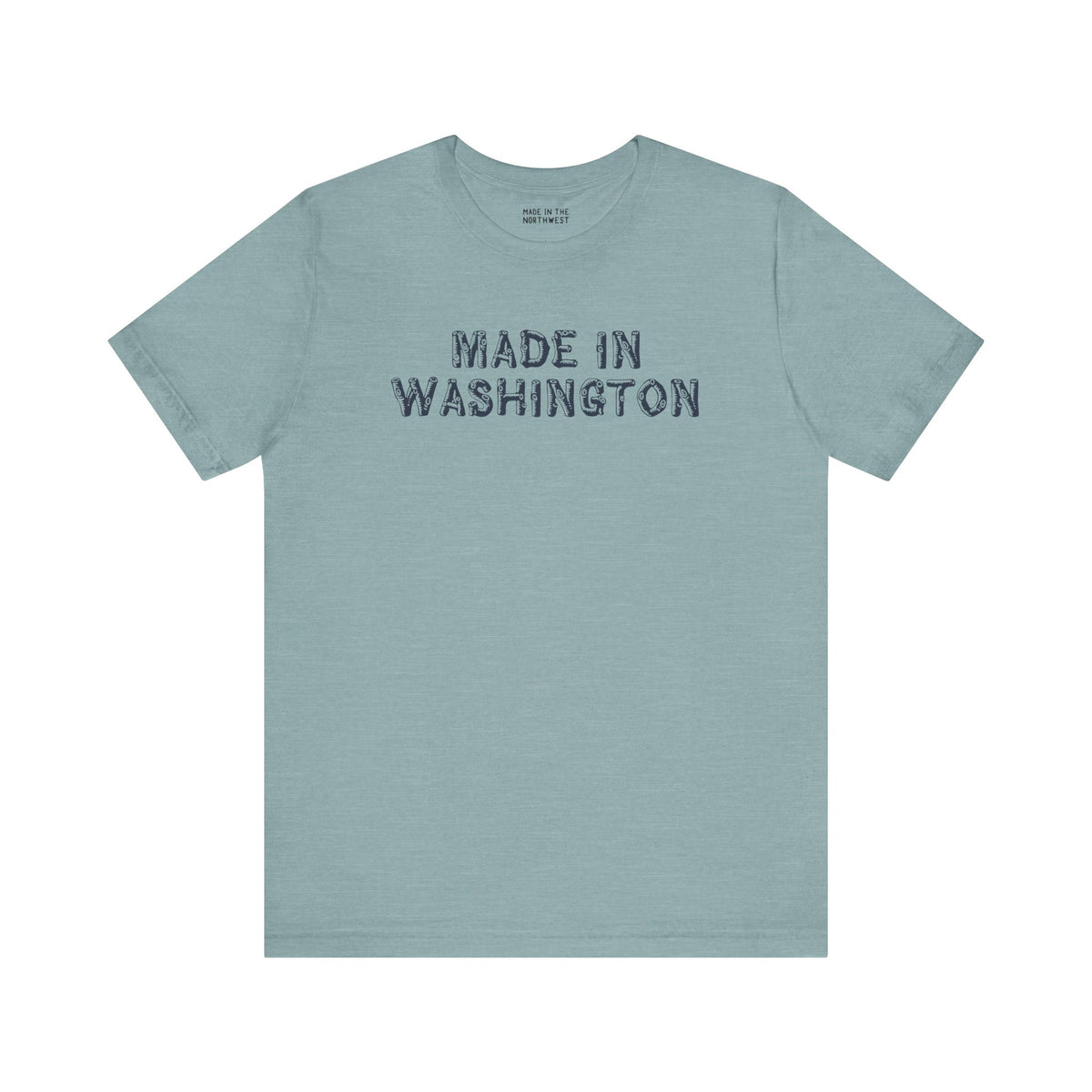 Light blue tee shirt with bold 'Made in Washington' wood log font, representing Pacific Northwest pride.