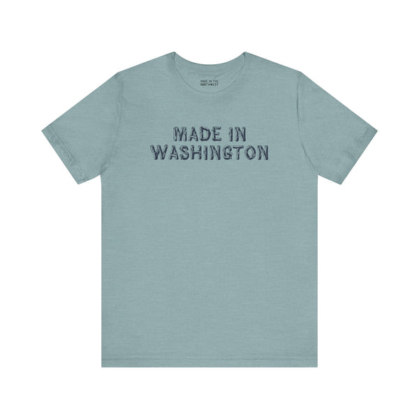Light blue tee shirt with bold 'Made in Washington' wood log font, representing Pacific Northwest pride.