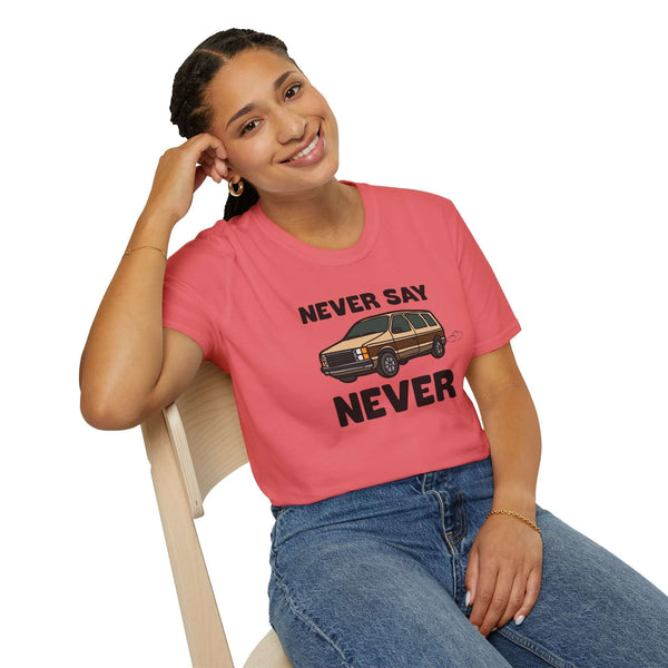 Woman wearing a pink Never Say Never vintage minivan t-shirt, smiling while sitting on a chair.
