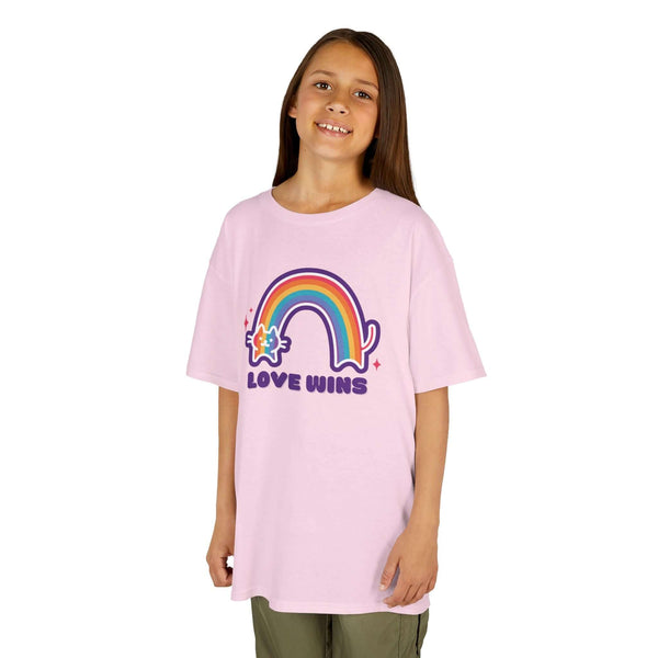 Girl wearing Love Wins rainbow kids' tee, featuring a colorful rainbow and cat design, promoting kindness and joy.