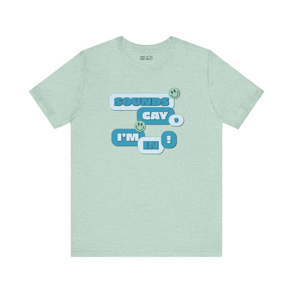 Sounds Gay I'm In! premium soft tee in mint green, featuring playful text and smiley faces for inclusive pride apparel.