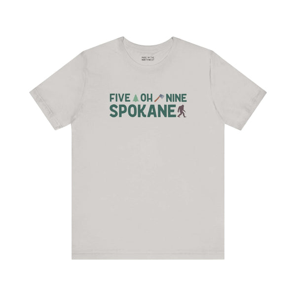 "Five Oh Nine Roots Soft Tee with Spokane text and axe, tree design, celebrating local pride and style"