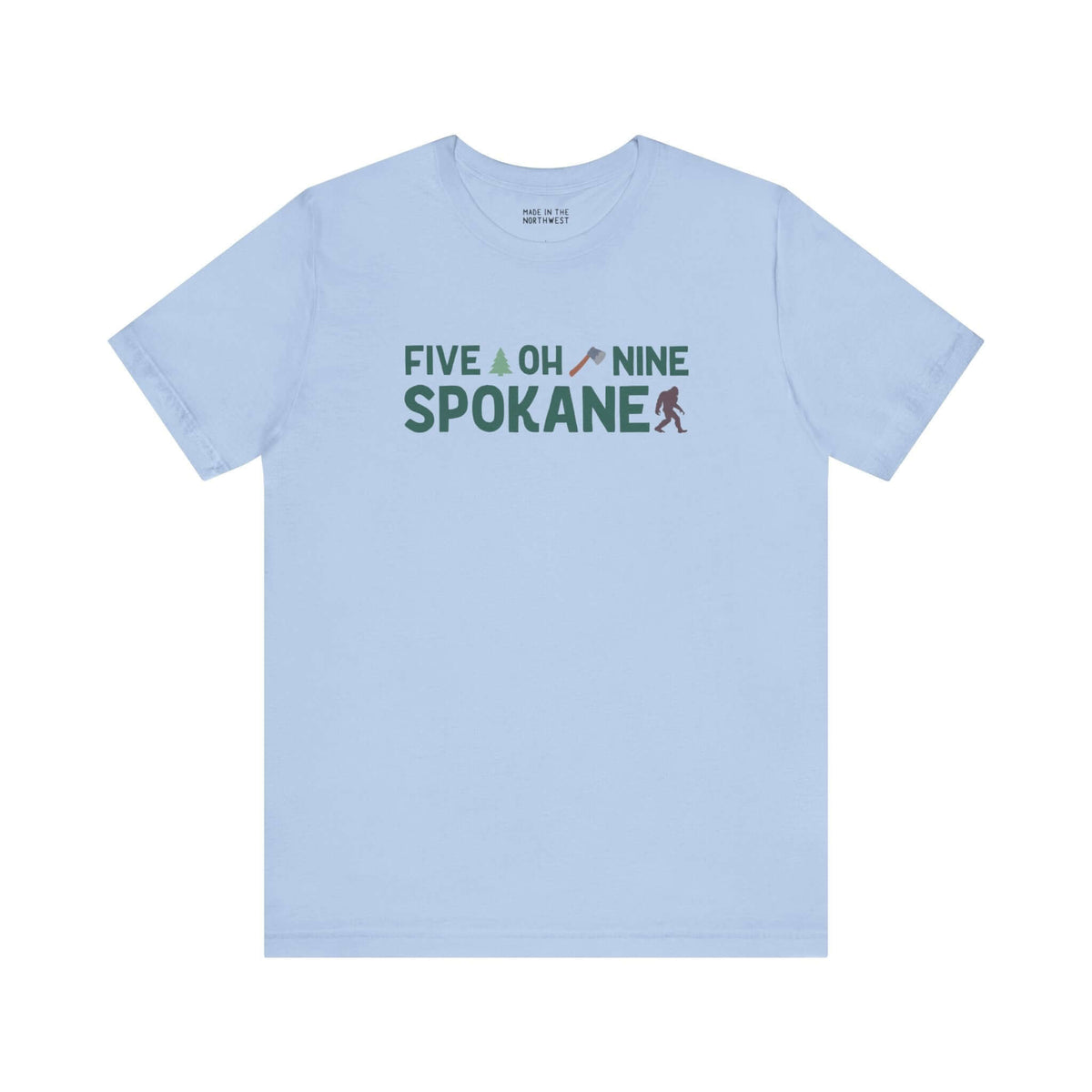 Light blue Spokane tee with "Five Oh Nine" text, featuring an axe and tree design, celebrating local pride and area code charm.