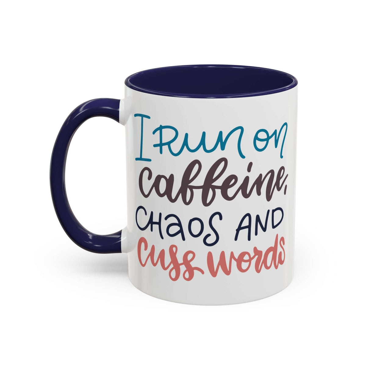 I Run on Caffeine, Chaos and Cuss Words Mug with colorful lettering on a white ceramic surface.