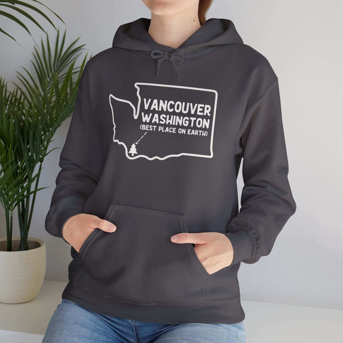 Woman wearing Vancouver Washington hoodie with bold graphic, hometown pride.