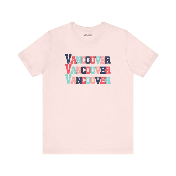 Bold Vancouver Trio Soft Tee with colorful block-letter design on a beige background, perfect for fans and locals.