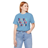 Woman wearing a Bold and Bright Seattle Trio Premium Soft Tee featuring colorful Seattle text design.