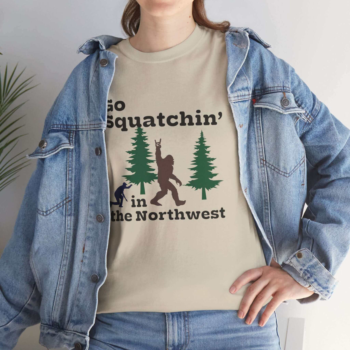 Person wearing Go Squatchin' in the Northwest athletic tee with Sasquatch design, perfect for Bigfoot enthusiasts and explorers.