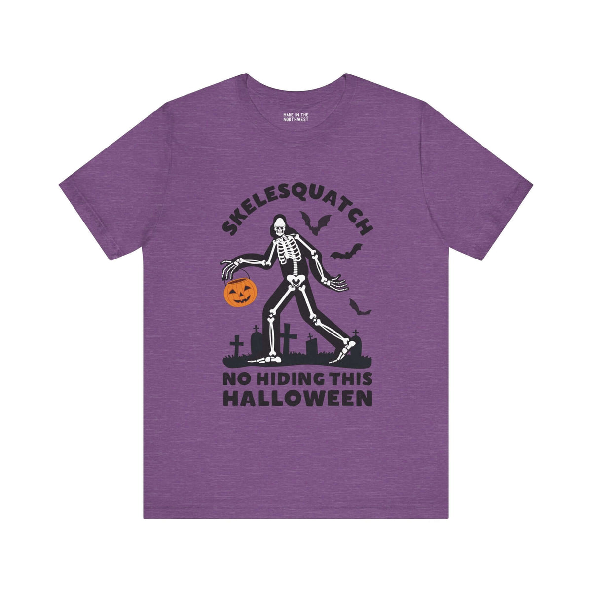 Purple Tee Featuring Skelesquatch Skeleton Sasquatch Design with Halloween Theme Walking in Graveyard Holding Pumpkin Bucket