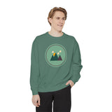 Minimalist Forest in a Northwest Style Garment Dyed Relaxed Sweatshirt worn by a man with mountain graphic.
