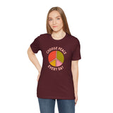Model wearing Choose Peace Every Day Premium Soft Tee with colorful peace symbol on maroon fabric.