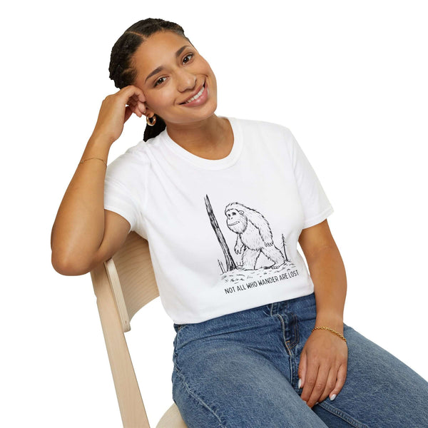 Smiling woman wearing a 'Not All Who Wander Are Lost' Bigfoot t-shirt, embodying a spirit of adventure.