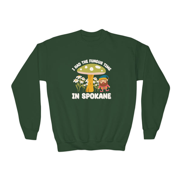 Green kids sweatshirt with gnome and mushroom design, 'I Had the Fungus Time in Spokane' slogan.