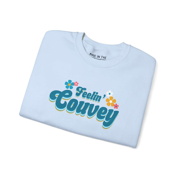 Feelin' Couvey retro sweatshirt in light blue, celebrating Vancouver with colorful text and flower graphics.
