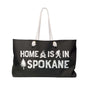 Home is in Spokane Weekender Bag showing campfire, sasquatch, and tree graphics on a stylish tote.