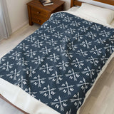 PNW Arrow Crossroads Lightweight Cozy Blanket featuring crossed arrows design on bed.