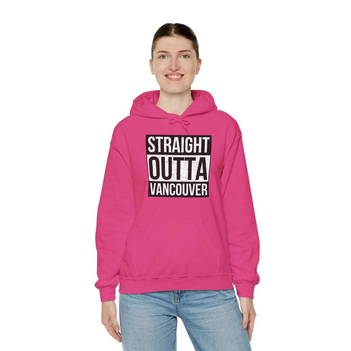 Woman wearing a pink "Straight Outta Vancouver" hoodie, showcasing bold city pride in streetwear fashion.