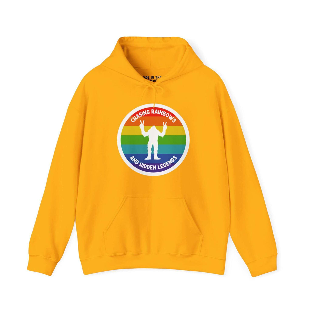 Yellow Sasquatch hoodie featuring a rainbow circle and "Chasing Rainbows and Hidden Legends" design, perfect for PNW enthusiasts.