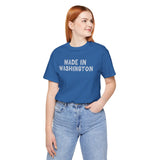 Woman wearing a blue tee with 'Made in Washington' text in wood log font, showcasing Pacific Northwest pride.
