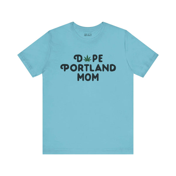 "Dope Portland Mom soft tee with marijuana leaf graphic in blue, celebrating laid-back motherhood and PDX pride"