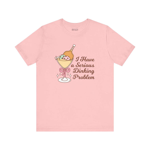 I Have a Serious Dinking Problem T Shirt featuring playful cocktail graphic on pink fabric.