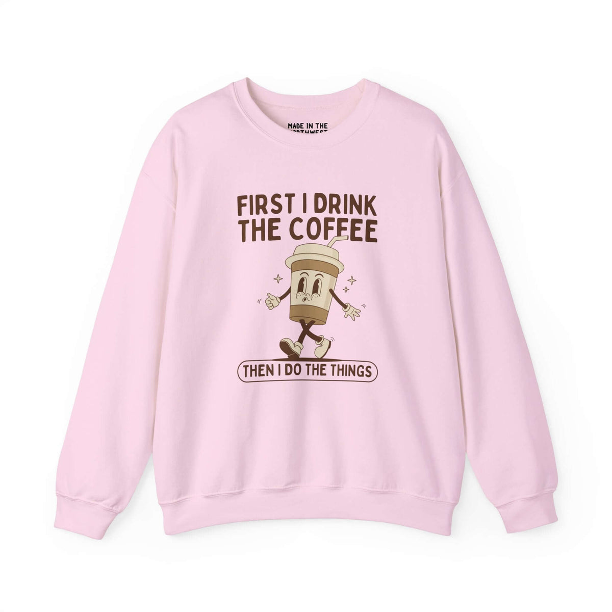 Light pink sweatshirt with the phrase 'First I Drink the Coffee Then I Do the Things' featuring a coffee cup graphic.